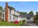 Well-maintained home exterior featuring a prominent brick chimney, lush lawn, and mature landscaping at 1321 South Point Rd, Belmont, NC 28012