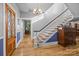 Grand foyer with beautiful hardwood floors, staircase, and elegant chandelier lighting at 1321 South Point Rd, Belmont, NC 28012