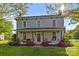 Charming two-story home with a inviting front porch and manicured landscaping at 1321 South Point Rd, Belmont, NC 28012