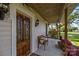 Inviting front porch with ornate wooden door, comfortable bench, and a relaxing swing at 1321 South Point Rd, Belmont, NC 28012