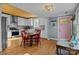 Charming kitchen with white cabinets, wood ceiling, stainless appliances and a dining table with red chairs at 1321 South Point Rd, Belmont, NC 28012