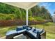 Inviting back porch with comfortable seating and a serene view of the surrounding greenery at 1390 Cedardale Ln, Denver, NC 28037