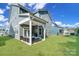 Inviting backyard with a covered patio and lounge furniture, great for outdoor relaxation at 1390 Cedardale Ln, Denver, NC 28037