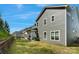 Well-maintained backyard with a gray home exterior and lush green lawn under a bright blue sky at 1390 Cedardale Ln, Denver, NC 28037