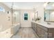 Modern bathroom featuring dual sinks, a large tiled shower with glass enclosure and a window at 1390 Cedardale Ln, Denver, NC 28037