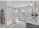 This primary bathroom features a modern shower with glass, dual sinks, and tile flooring at 1390 Cedardale Ln, Denver, NC 28037