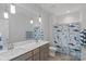 Bathroom with double sinks, modern lighting, and shower with decorative curtain at 1390 Cedardale Ln, Denver, NC 28037