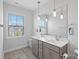 Modern bathroom featuring double sinks, a large mirror, and stylish pendant lighting at 1390 Cedardale Ln, Denver, NC 28037