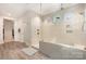 Clean, modern bath showcasing a large shower, stone tile flooring, and an open design at 1390 Cedardale Ln, Denver, NC 28037