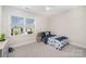 Bright bedroom with a large window offering views of the neighborhood at 1390 Cedardale Ln, Denver, NC 28037