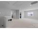 Spacious bonus room featuring neutral paint, carpet, and natural light from the large window at 1390 Cedardale Ln, Denver, NC 28037