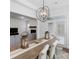Open dining room featuring a wooden table, modern lighting, and views into the living room at 1390 Cedardale Ln, Denver, NC 28037