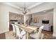 Bright dining room with stylish chandelier, dining table and chairs, with open concept living at 1390 Cedardale Ln, Denver, NC 28037