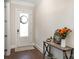 Charming home entry with a decorative wreath, hardwood floors, and a stylish entryway table at 1390 Cedardale Ln, Denver, NC 28037