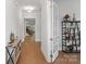 Welcoming hallway featuring stylish decor, hardwood floors, and seamless transition to other areas of the home at 1390 Cedardale Ln, Denver, NC 28037
