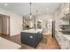 Well-appointed kitchen with white cabinets, stainless appliances, dark island, and hardwood flooring at 1390 Cedardale Ln, Denver, NC 28037