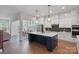 Spacious kitchen with white cabinets, stainless steel appliances, large island and hardwood flooring at 1390 Cedardale Ln, Denver, NC 28037