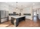 Spacious kitchen with white cabinets, large island, modern appliances, and hardwood floors at 1390 Cedardale Ln, Denver, NC 28037
