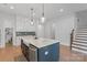 Stylish kitchen boasts marble island, custom cabinets, stainless appliances, and a convenient butler's pantry at 1390 Cedardale Ln, Denver, NC 28037