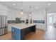 Modern kitchen featuring white cabinets, stainless steel appliances, a spacious island, and stylish pendant lighting at 1390 Cedardale Ln, Denver, NC 28037