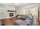 Comfortable living room with hardwood floors, a gray sectional sofa, and a cozy fireplace at 1390 Cedardale Ln, Denver, NC 28037