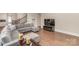 Open concept living room features hardwood floors and a comfortable sectional sofa and large screen TV at 1390 Cedardale Ln, Denver, NC 28037