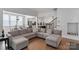 Inviting living room with a sectional sofa, hardwood floors, and seamless connection to the kitchen and dining areas at 1390 Cedardale Ln, Denver, NC 28037