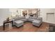 Open living room with hardwood floors, a gray sectional sofa, and open access to the kitchen at 1390 Cedardale Ln, Denver, NC 28037