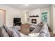 Inviting living room features a cozy fireplace, hardwood floors, and comfortable gray sofa seating at 1390 Cedardale Ln, Denver, NC 28037