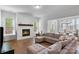 Inviting living room featuring a fireplace with herringbone accent wall and a comfortable sectional sofa at 1390 Cedardale Ln, Denver, NC 28037