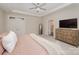 Comfortable main bedroom with a ceiling fan, ensuite bathroom, and a large dresser at 1390 Cedardale Ln, Denver, NC 28037