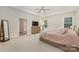 Light-filled main bedroom featuring a tray ceiling, plush carpeting, and a stylish dresser at 1390 Cedardale Ln, Denver, NC 28037