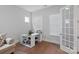 Bright office space with wood floors, two windows with blinds, and a desk with shelving at 1390 Cedardale Ln, Denver, NC 28037