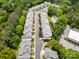 Aerial view of a community showcasing well-maintained townhomes, landscaping, and a swimming pool at 14457 Adair Manor Ct, Charlotte, NC 28277