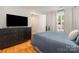 Spacious bedroom with a large television, dresser, and window, offering a comfortable and functional living space at 14457 Adair Manor Ct, Charlotte, NC 28277
