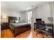 Comfortable bedroom featuring a large bed, a window, and a desk area perfect for work or study at 14457 Adair Manor Ct, Charlotte, NC 28277