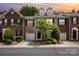 Charming brick townhome featuring a front-entry garage and meticulously landscaped front yard at 14457 Adair Manor Ct, Charlotte, NC 28277
