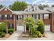 Charming brick townhome featuring a front-entry garage and meticulously landscaped front yard at 14457 Adair Manor Ct, Charlotte, NC 28277