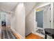 Hallway leading to laundry room with wooden floors and neutral paint for a clean aesthetic at 14457 Adair Manor Ct, Charlotte, NC 28277