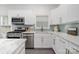Bright kitchen with stainless steel appliances, light backsplash, and a marble countertop at 14457 Adair Manor Ct, Charlotte, NC 28277
