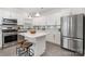 Stylish kitchen featuring white cabinets, stainless steel appliances, and a marble-topped island at 14457 Adair Manor Ct, Charlotte, NC 28277