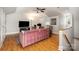 Cozy living room with hardwood floors, modern ceiling fan and a pink sofa in a brightly lit room at 14457 Adair Manor Ct, Charlotte, NC 28277