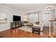 Inviting living room with hardwood floors, decorative cabinet, and a large window at 14457 Adair Manor Ct, Charlotte, NC 28277