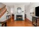 Cozy living room featuring a beautiful marble fireplace and hardwood floors at 14457 Adair Manor Ct, Charlotte, NC 28277