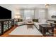 Inviting living room with hardwood floors, decorative cabinet, and a large window at 14457 Adair Manor Ct, Charlotte, NC 28277