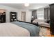 Spacious main bedroom with sitting area and ensuite access featuring a comfortable bed with a blue throw blanket at 14457 Adair Manor Ct, Charlotte, NC 28277