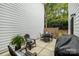 Outdoor patio with a dining set, and cozy lounge chair in a private backyard at 14457 Adair Manor Ct, Charlotte, NC 28277
