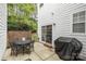 Outdoor patio with dining set and covered grill, perfect for entertaining in a private backyard at 14457 Adair Manor Ct, Charlotte, NC 28277