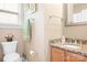 This bathroom features granite counters, wood cabinets, a sink and a toilet at 14541 Holly Springs Dr, Huntersville, NC 28078