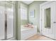 Bright bathroom with a separate shower and tub as well as decorative art at 14541 Holly Springs Dr, Huntersville, NC 28078